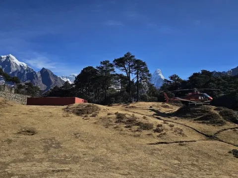 Helicopter at Hotel Everest View Helipad and mountains