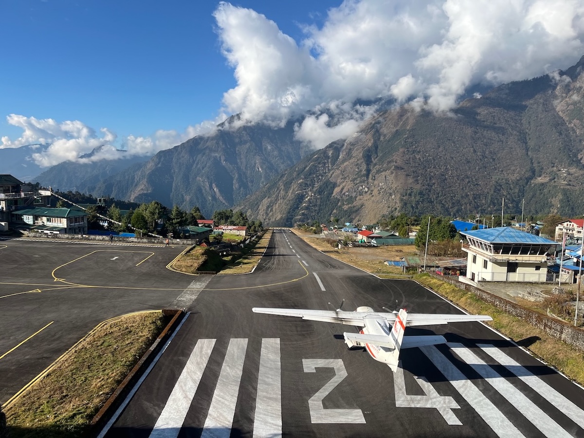 Lukla Airport runway with a small aircraft in the Everest region Nepal
